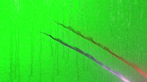 Abstract glowing light streaks on a green rainy window background Stock Footage 341733035