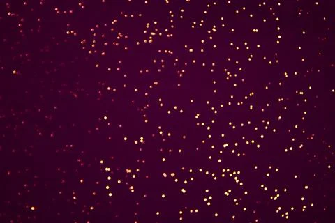 Abstract glowing lights on a violet background. Dark purple background with Stock Photos