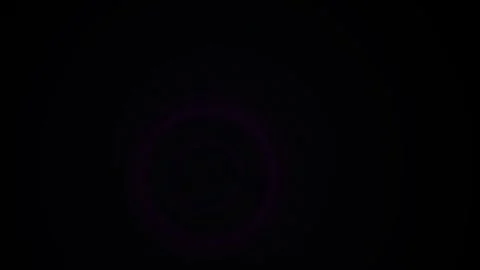 Abstract glowing purple light dot pulsing on dark pitch black background. Stock Footage 346338524