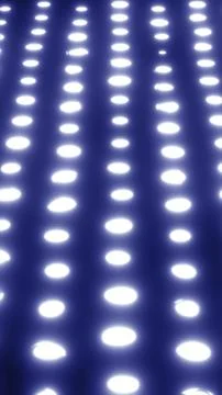 Abstract glowing rows of bright white dots fading into a dark background Stock Photos