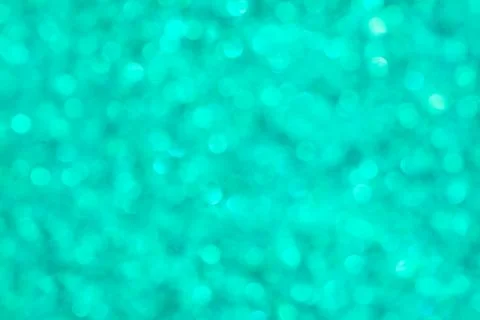 Abstract glowing teal background, texture, glitter vintage glare, bokeh Stock Photos