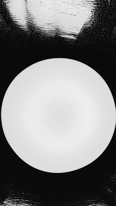 Abstract glowing white circle on dark textured surface with water droplets Stock Footage 327130911