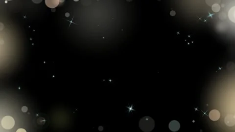 Abstract golden bokeh particles floating against deep dark background with Vidéo 345332943