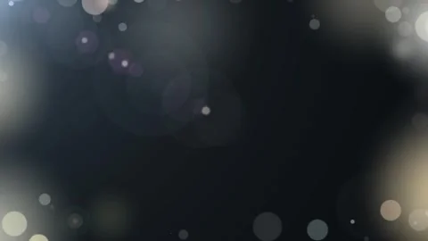 Abstract golden bokeh particles floating against dark background for elegant Stock Footage 345333002