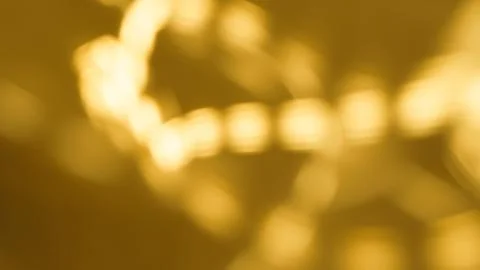 Abstract golden light patterns with blurred bokeh effect in background Foto stock