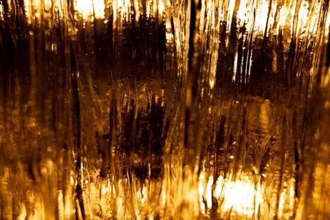 Abstract golden light through textured glass surface Stock Photos