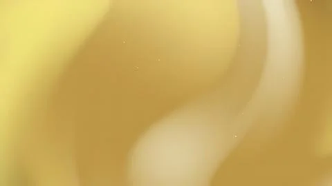 Abstract Golden Liquid Reflection with Soft Light Waves and Glowing Sparkle.. 库存照片