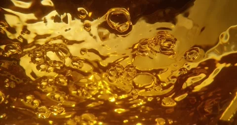 Abstract golden liquid texture with rising bubbles captured in slow motion .. Stock Footage 337596744