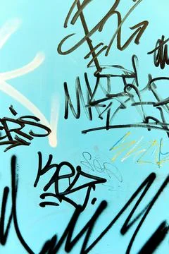 Abstract graffiti on blue background wall Stock Photos