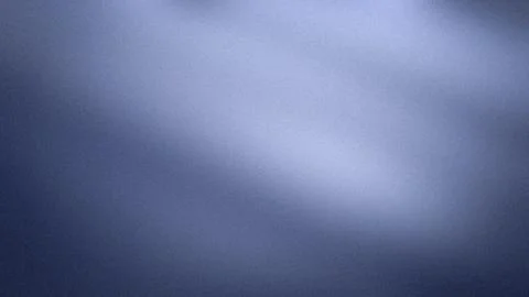 Abstract grainy blue backdrop with dark navy and light gray gradient for 4K.. Stock Photos