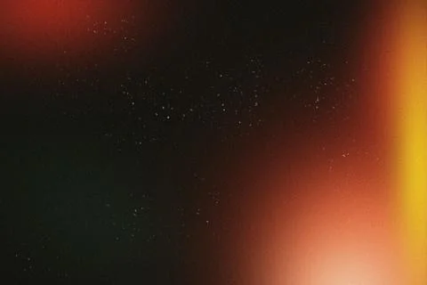Abstract grainy dark background with glowing orange and red light gradients.. Stock Illustration
