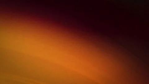 Abstract grainy gradient background with rich blends of dark red, amber, an.. Stock Photos