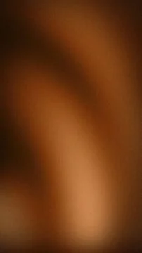 Abstract grainy gradient background with warm brown bronze and copper luxur.. Stock Photos
