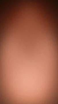 Abstract grainy gradient background with warm brown colors and dark vignette Stock Photos