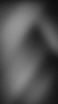 Abstract grainy gradient in black, grey, and white tones. Minimalist blurre.. Stock Photos