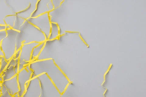 Abstract gray background with bright yellow wavy paper stripes. Stock Photos