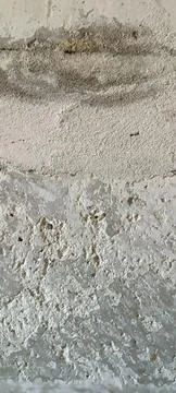 Abstract gray background. Gray old concrete wall with traces of plaster and Stock Photos
