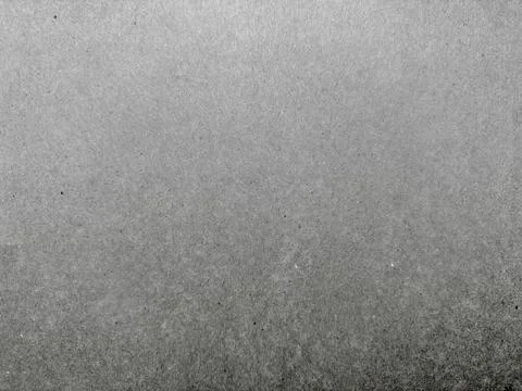 Abstract gray grainy texture captures soft gradient with subtle speckles in s Stock Photos