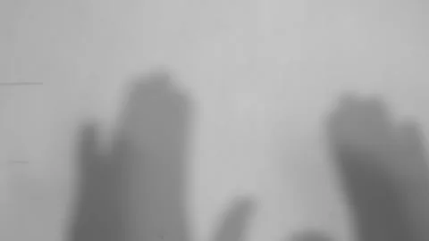 Abstract gray shadows of hand waving on pink wall Stock Footage 251413827