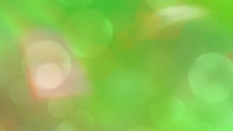 Abstract green background featuring soft glowing bokeh circles and warm golden Stock Footage 345217043