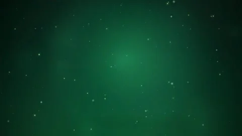 Abstract green glowing particles floating in dark space with soft light bokeh Stock Footage 345428964