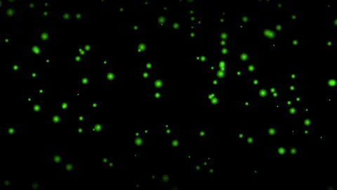 Abstract green glowing particles floating in dark space 動画素材 345975666