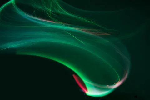 Abstract green light streaks creating dynamic energy wave Stock Photos