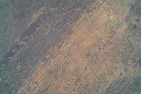 Abstract ground texture with diagonal dark grey and rust orange soil patterns Stock Photos