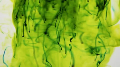 Abstract gush of green drops diffusing in transparent liquid over a white Stock-Footage 201332361