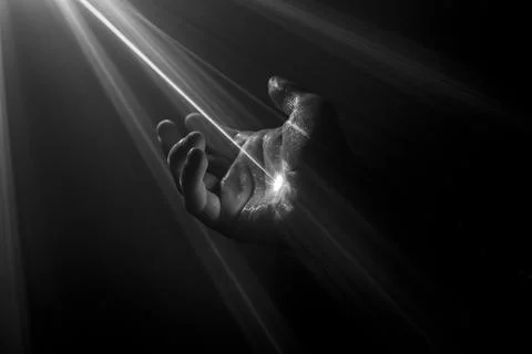 Abstract Hand with light ray going through the palm Stock Photos