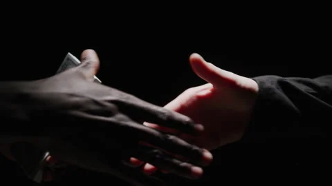 Abstract Hands Making a Deal with a Stack of 100 Dollar Bills in Darkness Stock Footage 208799649
