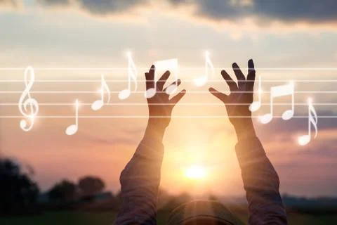 Abstract hands touching music notes on nature background Фото