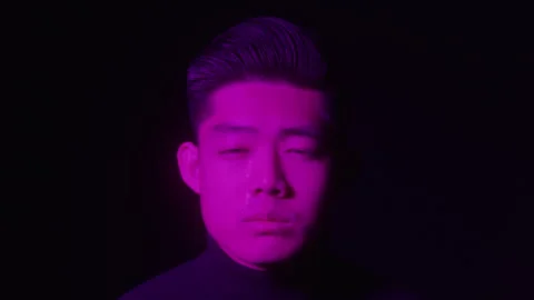 Abstract Headshot Portrait of Sad Male Model Under Colorful Studio Lights Stock Footage 270305853