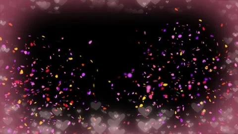 Abstract heart bokeh background featuring floating colorful petals on a dark Stock Footage 345335078