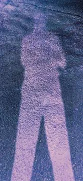 Abstract Human Shadow on Blue Violet Textured Road Stock Photos