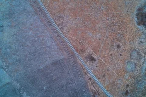 Abstract ice crystals pattern on frozen ground presenting white frost feathers 写真素材
