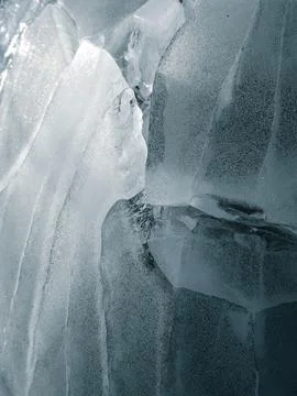 Abstract ice texture. Blue background with cracks on surface. Close-up. Stock Photos