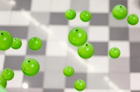 Abstract image of 3d green spheres falling on gray background Stock Illustration