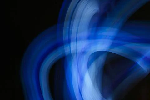 Abstract image of blue neon light painting in a circular and spiral pattern.. Stock Illustration