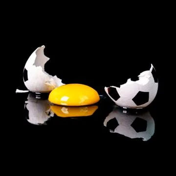 An abstract image of a broken egg in the form of a soccer ball symbolizing a  Stock Photos