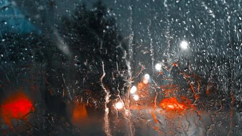 Abstract image of drops of rain on window with night reflections lights Stock Photos