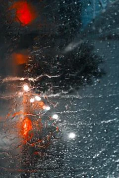 Abstract image of drops of rain on window with night reflections lights Stock Photos