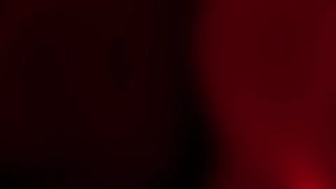 This abstract image features dark red light gradients on a black background. Video stock 334823574