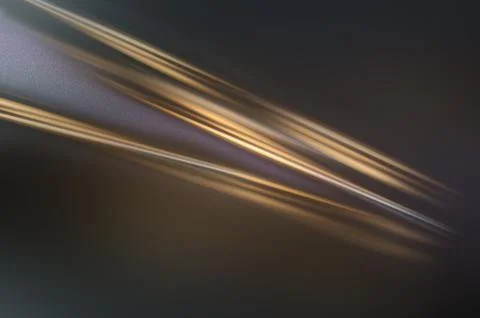 Abstract image featuring smooth, elongated streaks of light in warm golden .. Stock Illustration