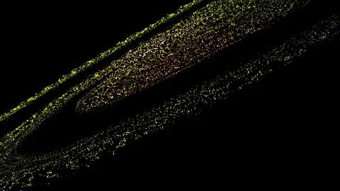 Abstract image featuring swirls of yellow particles on a black background 스톡 동영상 280531415