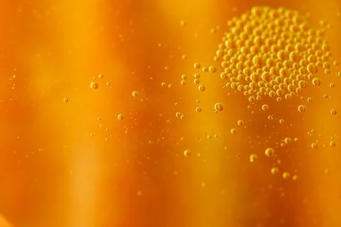 Abstract image of golden liquid with bubbles, creating a textured, vibrant .. Stock Photos