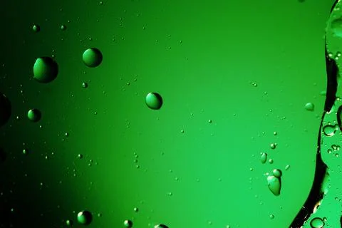 Abstract image of green liquid with bubbles and droplets. Stock Photos