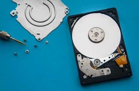 The abstract image of inside of hard disk drive on blue cover and screw driver Stock Photos