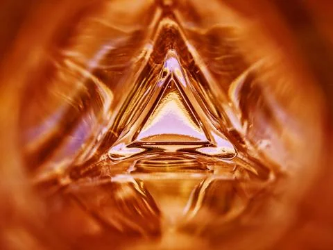 Abstract image of the inside of a triangle glass bottle red color background Stock Photos