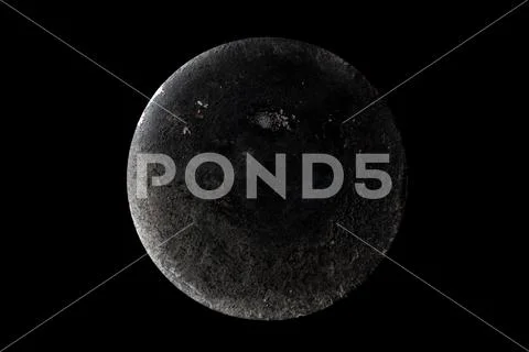 Abstract image of planet Moon from the surface of an old griddle on a black b Stock Photos